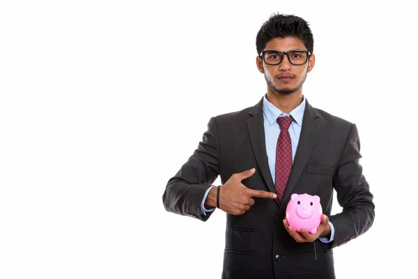 Studioaufnahme Eines Jungen Gut Aussehenden Indischen Geschäftsmannes Der Ein Sparschwein — Stockfoto