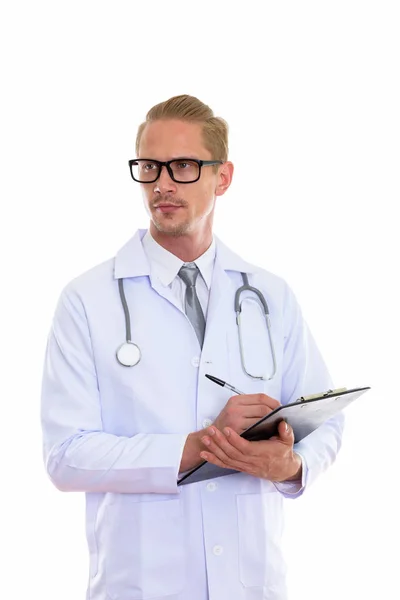 Young Handsome Man Doctor Thinking Looking Distance While Writing Clipboard — Stock Photo, Image