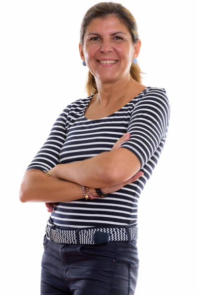 Studio shot of mature happy woman smiling with arms crossed — Stock Photo, Image