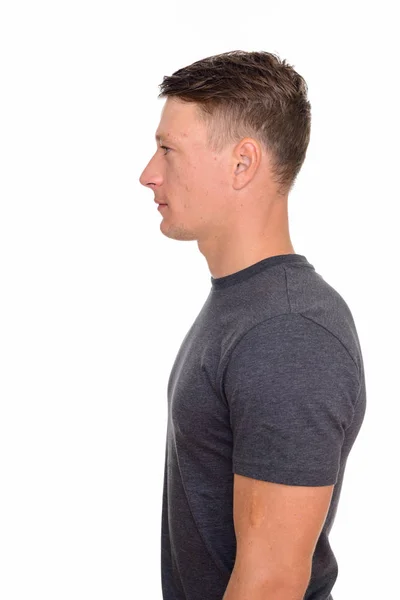 Side view of young handsome Caucasian man isolated against white — Stock Photo, Image