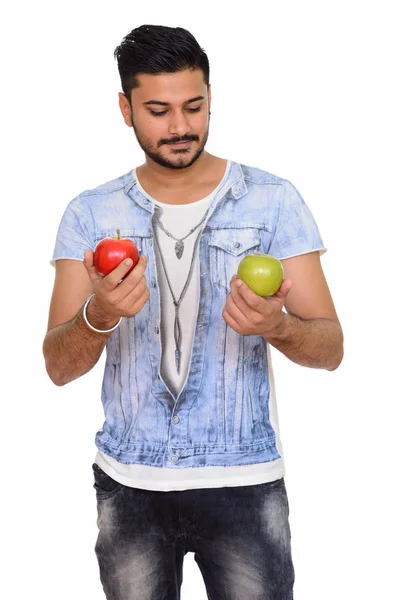 Young handsome Indian man holding red and green apple — Stock Photo, Image