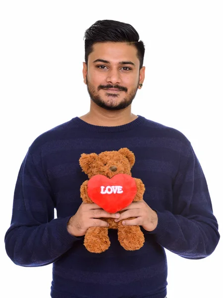 Młody przystojny Indian człowiek gotowy na Walentynki, trzymając tedd — Zdjęcie stockowe