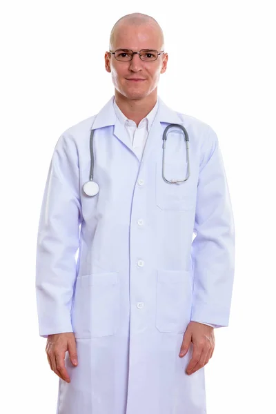 Studio shot of young handsome bald man doctor standing while wea — Stock Photo, Image