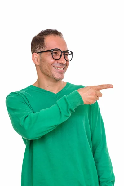 Mature happy Persian man pointing finger on the side — Stock Photo, Image