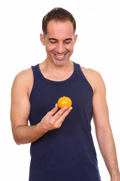 Mature heureux persan homme tenant orange — Photo
