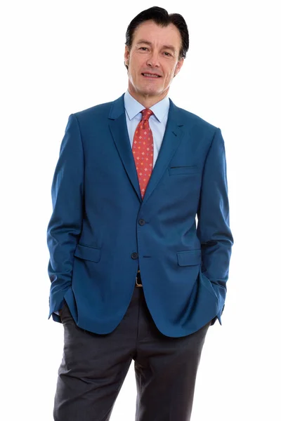 Studio shot of mature happy businessman smiling and standing — Stock Photo, Image