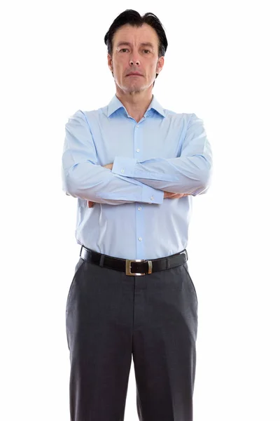 Studio shot of mature handsome businessman standing with arms cr — Stock Photo, Image