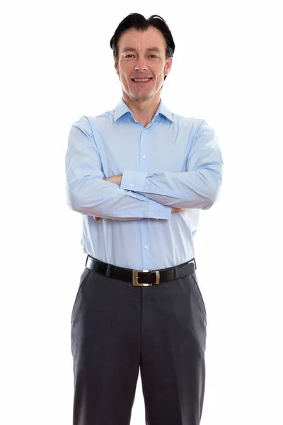 Studio shot of mature happy businessman smiling and standing wit — Stock Photo, Image