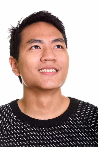 Face of young happy Asian man smiling while thinking — Stock Photo, Image