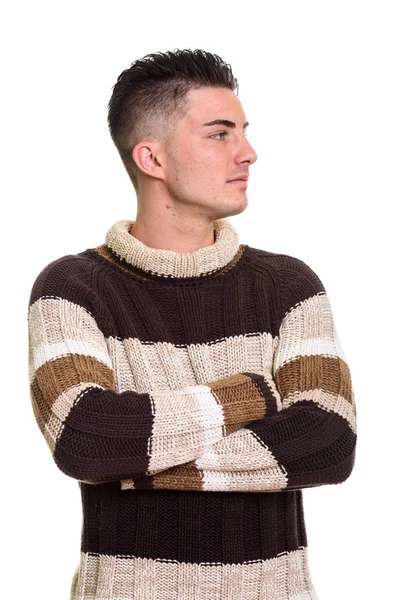 Studio shot of young handsome man looking away with arms crossed — Stock Photo, Image