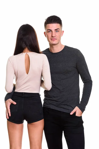 Studio shot of young couple with back view of woman — Stock Photo, Image
