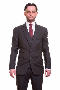 Ayakta duran genç iş adamının stüdyo fotoğrafı.
