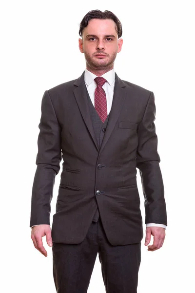 Студійний знімок молодого бізнесмена стоїть — стокове фото