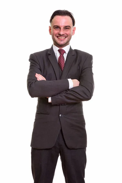Studioaufnahme eines glücklichen Geschäftsmannes, der mit verschränkten Armen lächelt — Stockfoto