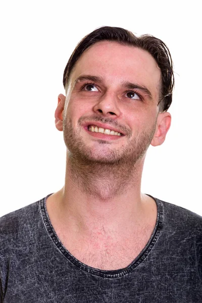 Face of young happy man smiling while thinking — Stock Photo, Image