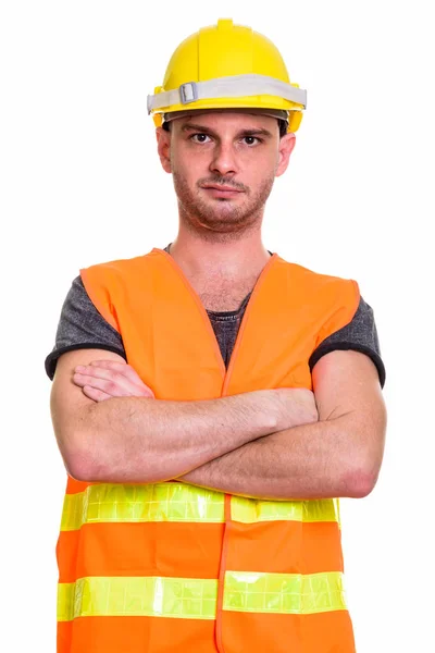 Studio bild av ung man byggnadsarbetare med armarna korsade — Stockfoto