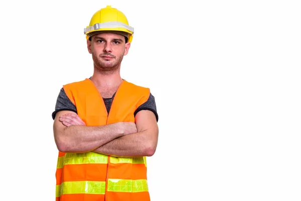 Studio záběr mladého muže stavební dělník se zkříženými pažemi — Stock fotografie