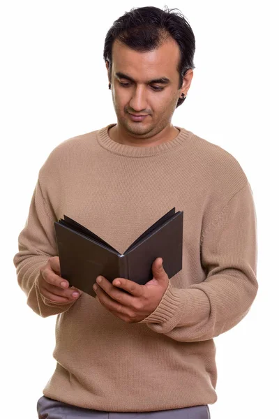 Studio shot of Persian man reading book — Stock Photo, Image