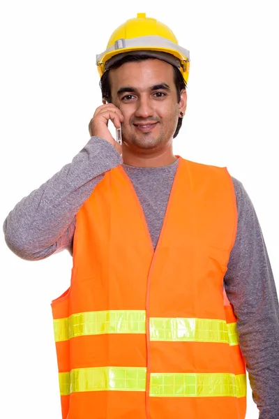 M üzerinde konuşurken gülümseyen mutlu Farsça adam inşaat işçisi — Stok fotoğraf