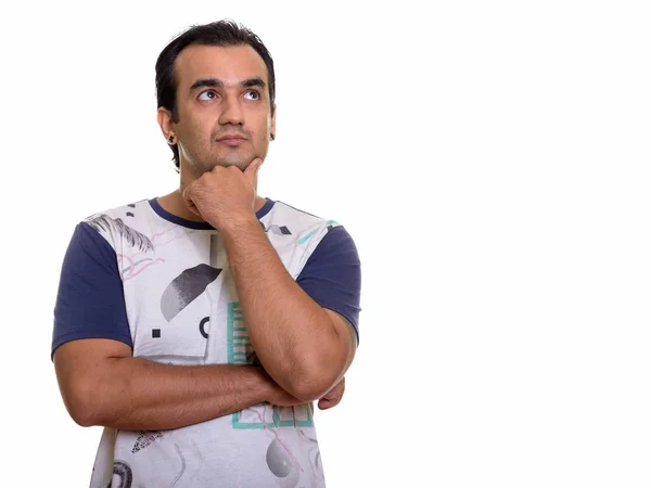 Studio shot of Persian man thinking while looking up — Stock Photo, Image