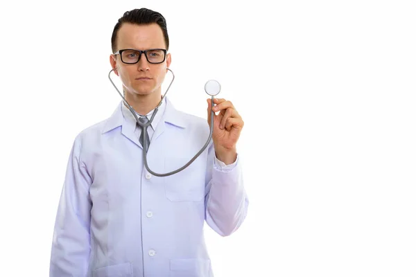 Studio shot of young handsome man doctor using stethoscope — Stock Photo, Image