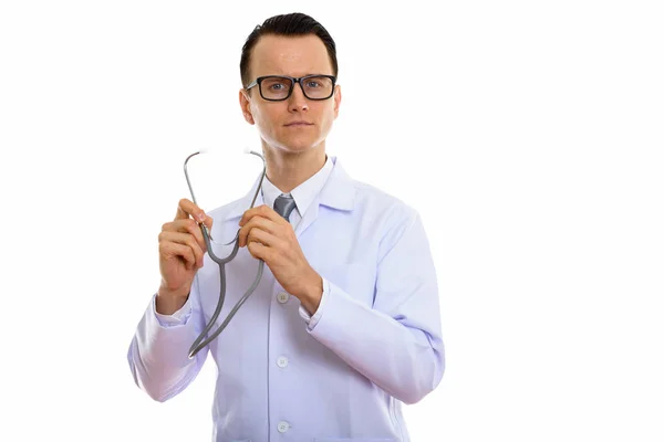 Studio shot of young handsome man doctor opening stethoscope — Stock Photo, Image