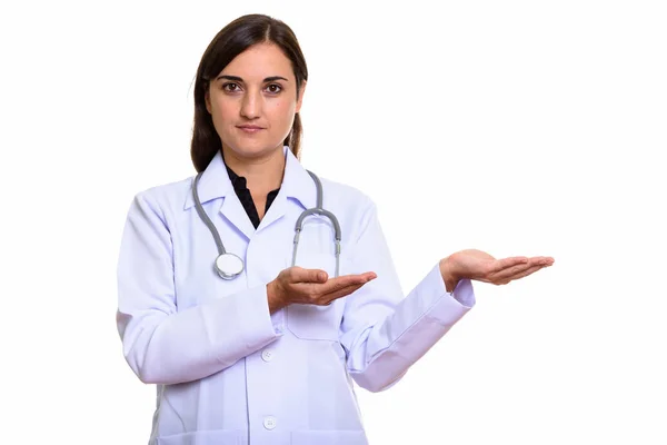 Studio shot of beautiful woman doctor showing something — Stock Photo, Image