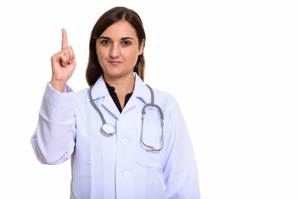 Studio shot of beautiful woman doctor pointing finger up — Stock Photo, Image