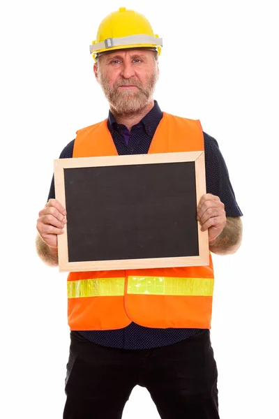 Mature bearded man construction worker holding blank blackboard — Stock Photo, Image