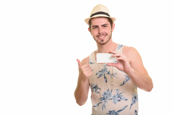 Joven feliz caucásico hombre sosteniendo el teléfono móvil y dando el pulgar — Foto de Stock