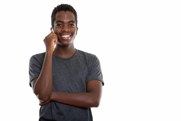 Studio shot of young happy black African teenage boy smiling and — Stock Photo, Image