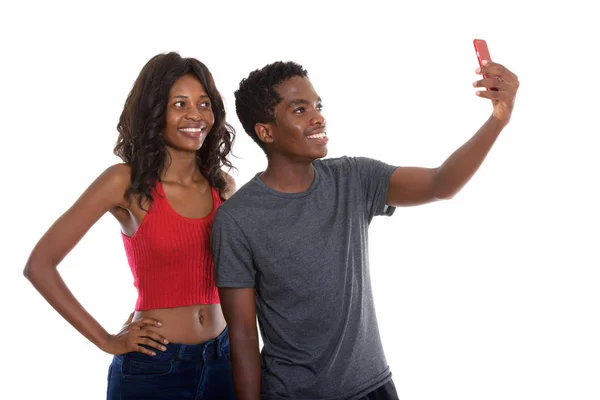 Studio shot of happy black African sister and brother smiling wh — Stock Photo, Image