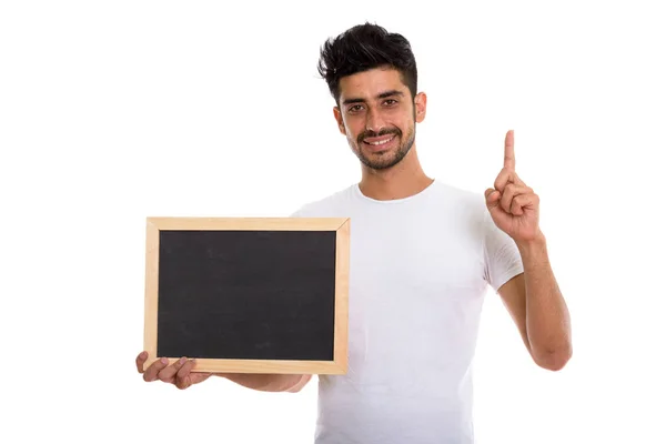 Studio colpo di giovane felice uomo persiano sorridente mentre tiene bla — Foto Stock