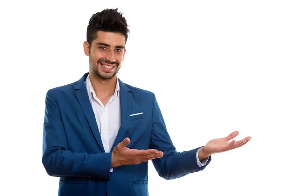 Studio shot of young happy Persian businessman smiling while sho — Stock Photo, Image