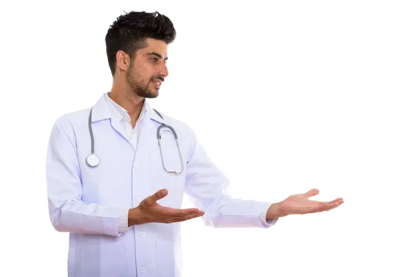 Profile view of young Persian man doctor showing something — Stock Photo, Image