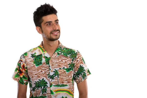 Studio shot of young happy Persian tourist man smiling while loo — Stock Photo, Image