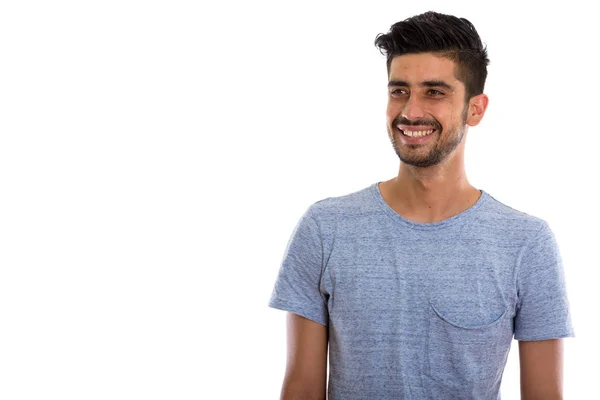 Estudio disparo de joven feliz persa hombre sonriendo y pensando —  Fotos de Stock