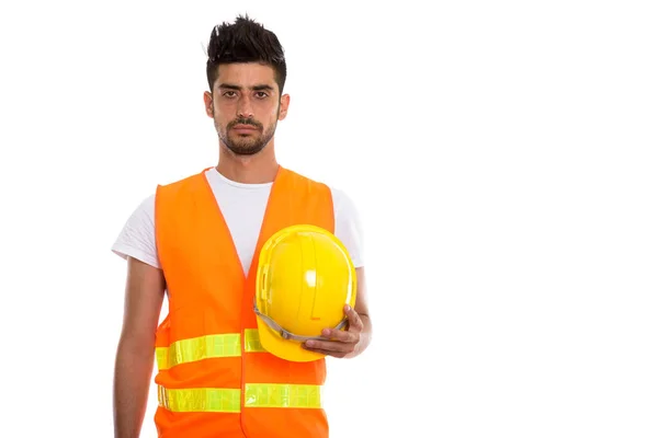 Estudio de la toma de joven persa trabajador de la construcción que sostiene har —  Fotos de Stock