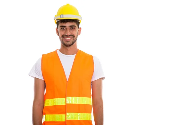 Studio shot of young happy Persian man construction worker smili — Stock Photo, Image