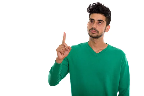 Studio skott av ung Persiska man tänker medan pekande finger — Stockfoto