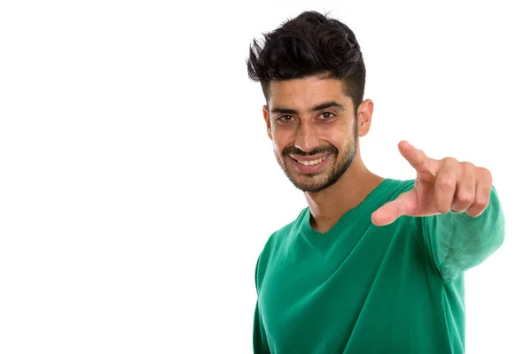 Studio skott av unga lycklig Persiska man ler medan pekar på — Stockfoto