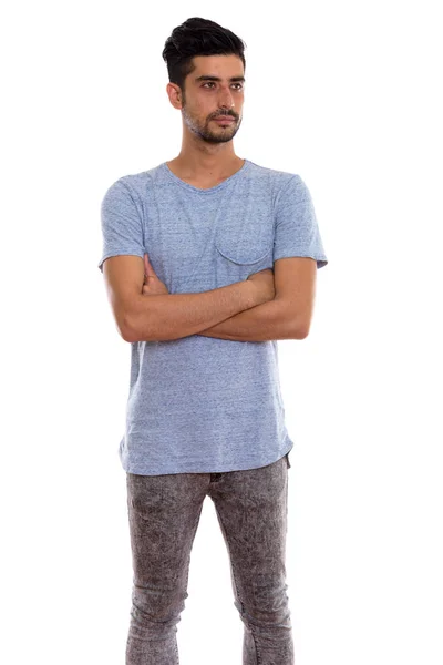 Studio shot of young Persian man standing and thinking with arms — Stock Photo, Image