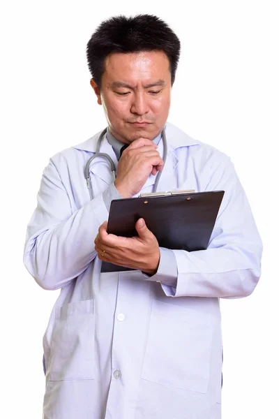 Японский врач читает на планшете, думая: — стоковое фото