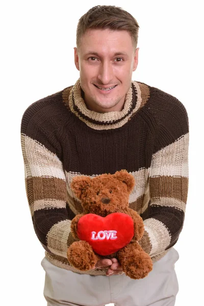 Счастливый красавец кавказский мужчина с любовью держит плюшевого медведя, а он — стоковое фото