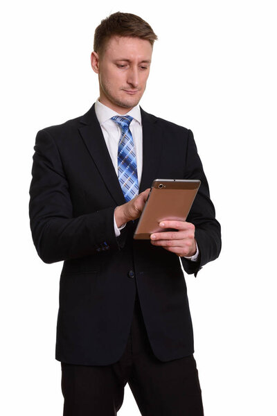 Handsome Caucasian businessman using digital tablet