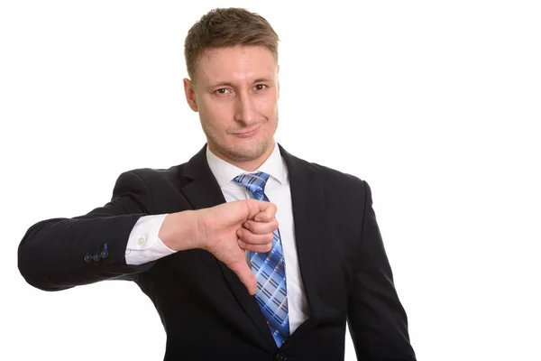 Handsome Caucasian businessman giving thumb down — Stock Photo, Image