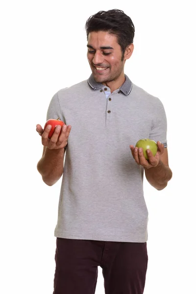 Joven hombre persa feliz sosteniendo manzana roja y verde — Foto de Stock