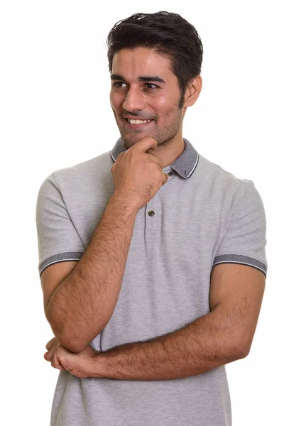 Nuori onnellinen persialainen mies ajattelee — kuvapankkivalokuva