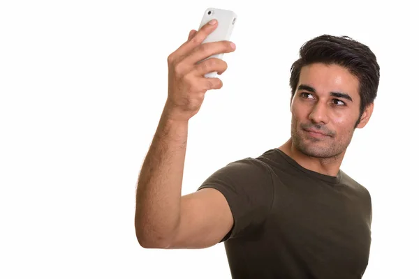 Young handsome Persian man taking selfie with mobile phone — Stock Photo, Image