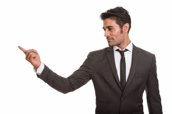 Young handsome Persian businessman pointing finger showing somet — Stock Photo, Image